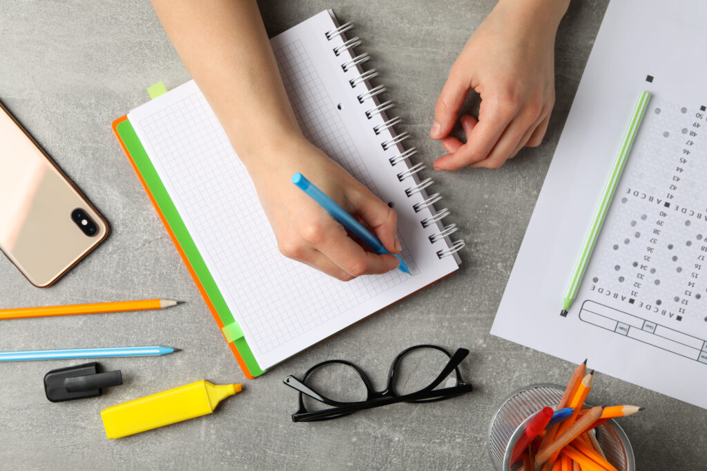 person writes in a notebook on grey background to 2021 09 02 21 30 27 utc