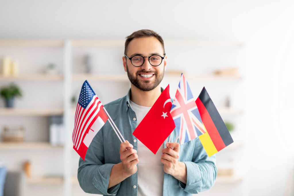 handsome young guy holding bunch of diverse flags 2023 11 27 05 33 57 utc