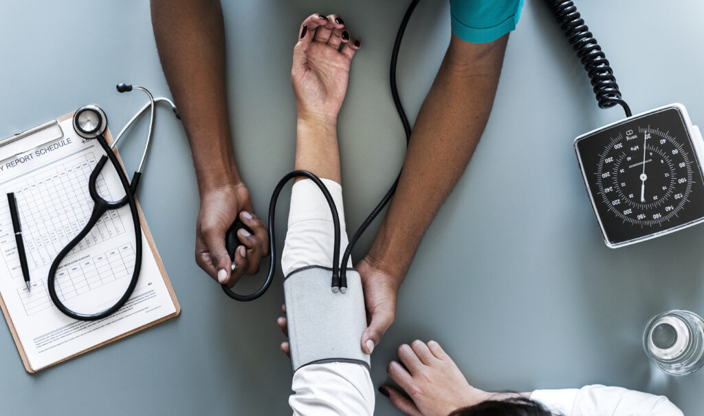 nurse measuring patient blood pressure